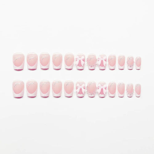 Short square French manicure artificial nails with white bow and floral patterns.