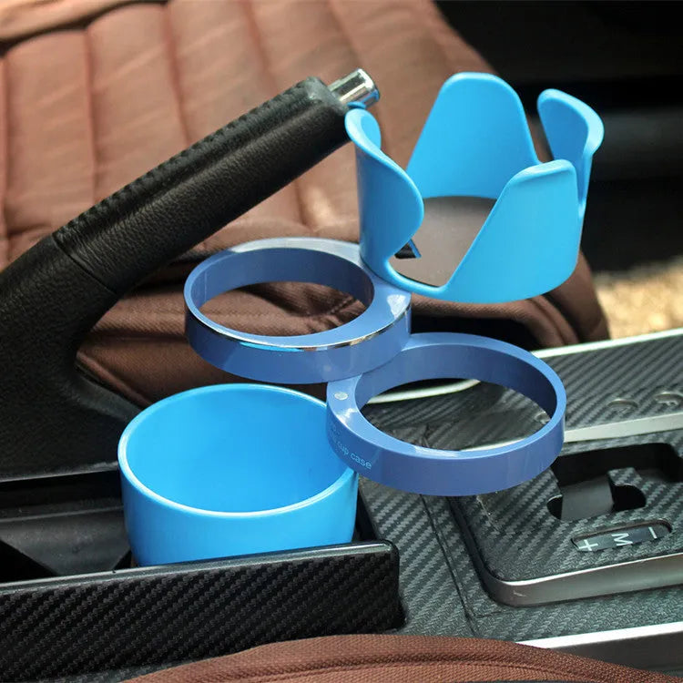 Black car multifunction cup holder and phone holder mounted on a car air vent.