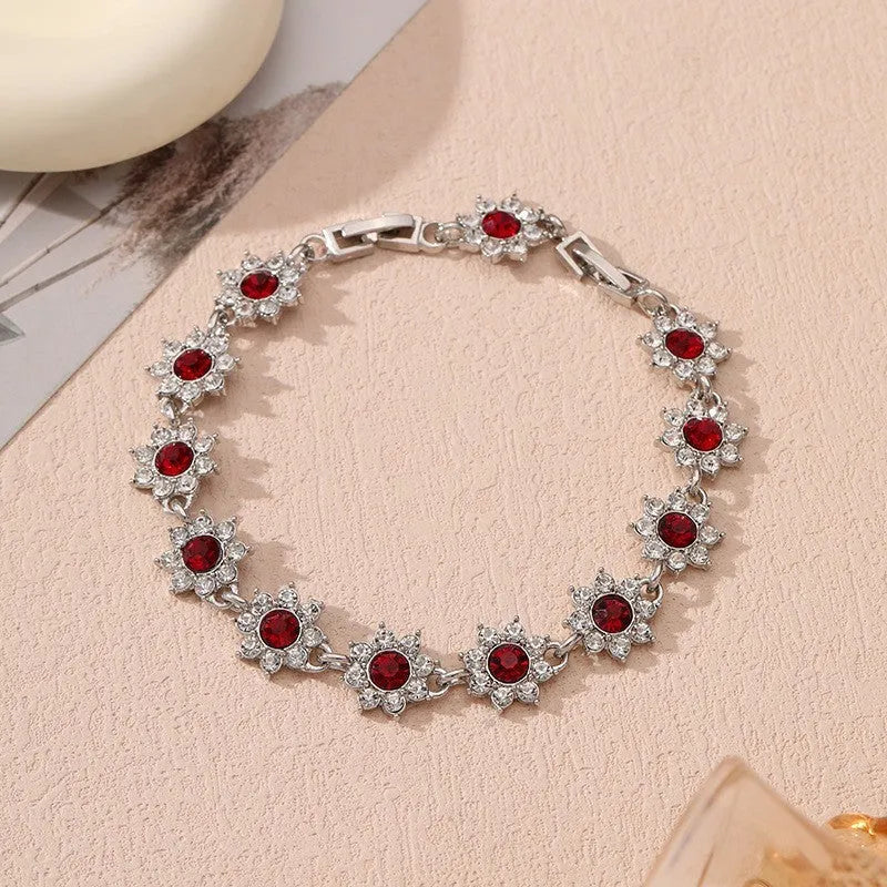 Coloured gemstone bracelet with flower-shaped design in gold and silver colour variations