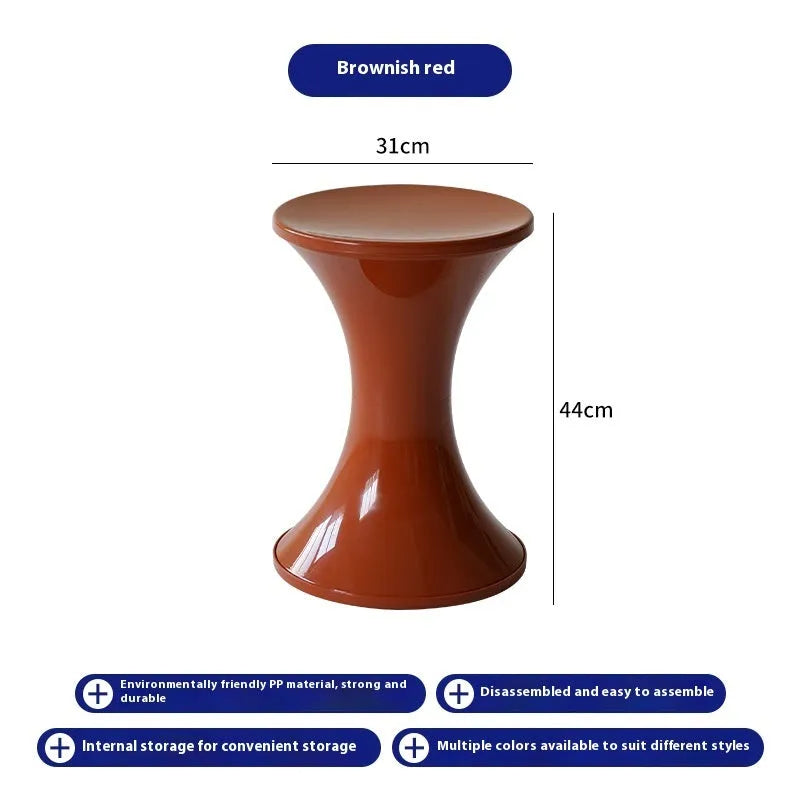 Creative hourglass-shaped plastic stool for changing shoes, shown in a green colour.