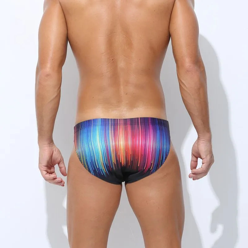 Men's printed polyester swimming trunks on a size chart, showing colour options: Cyber, Ice Cream, Streamer, Skull.