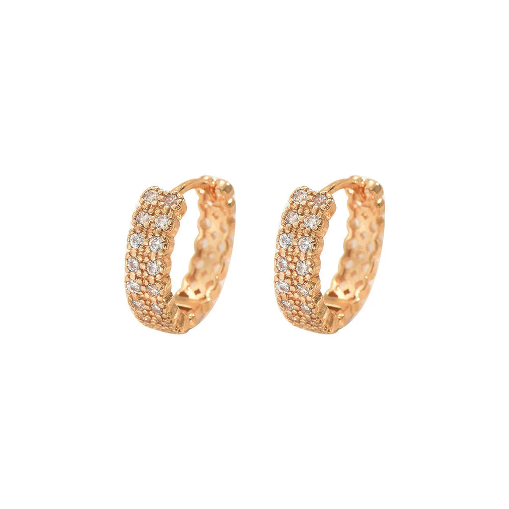 A pair of copper geometric ear studs featuring a round ring with a central dot, on a grey background.