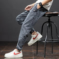Men's straight leg cargo casual jeans in cotton, showing Korean style and skinny open leg.