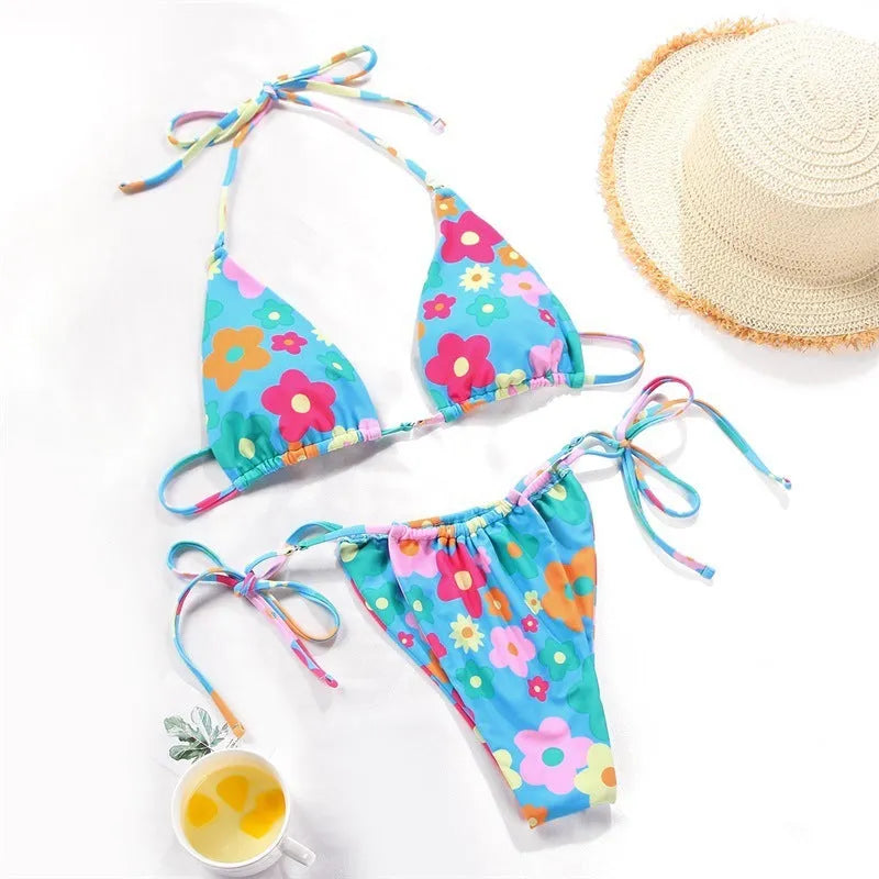 Women's polka dot and floral print split swimsuit bikini set on a mannequin.