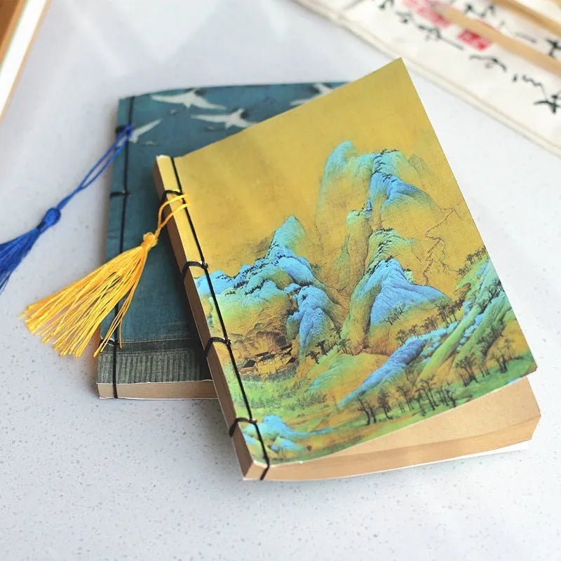 Antique wire-bound notebook with historical artwork cover and decorative tassels