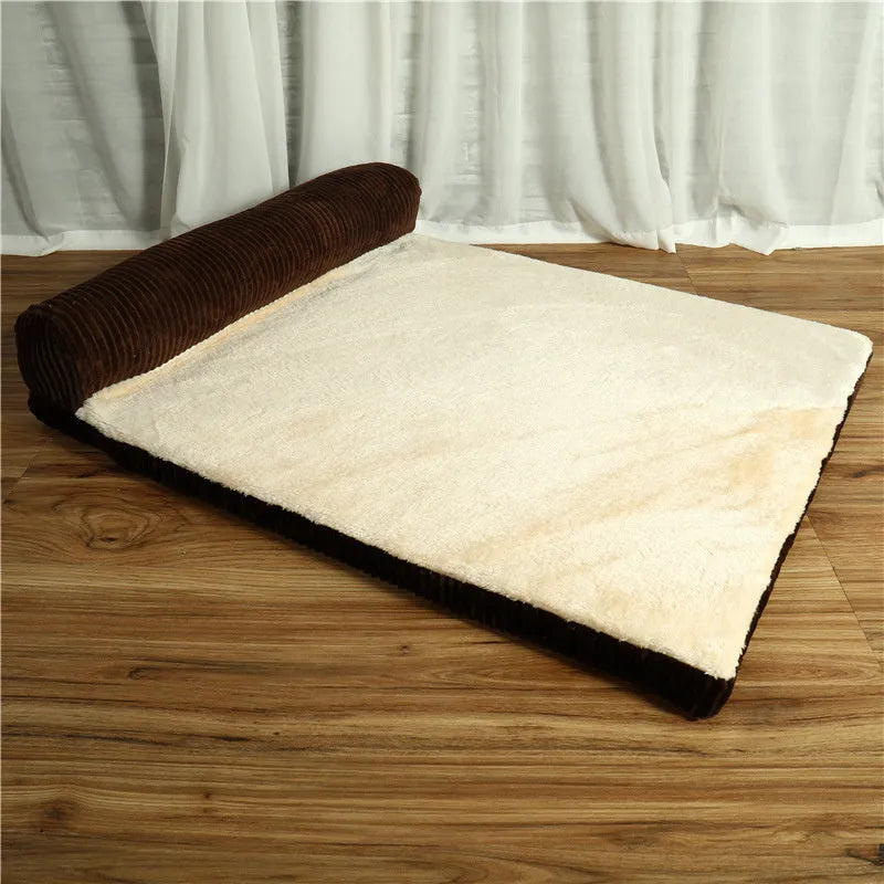 Grey corduroy pet sofa dog bed with bilateral bolsters and a non-slip cloth base on a wooden floor.