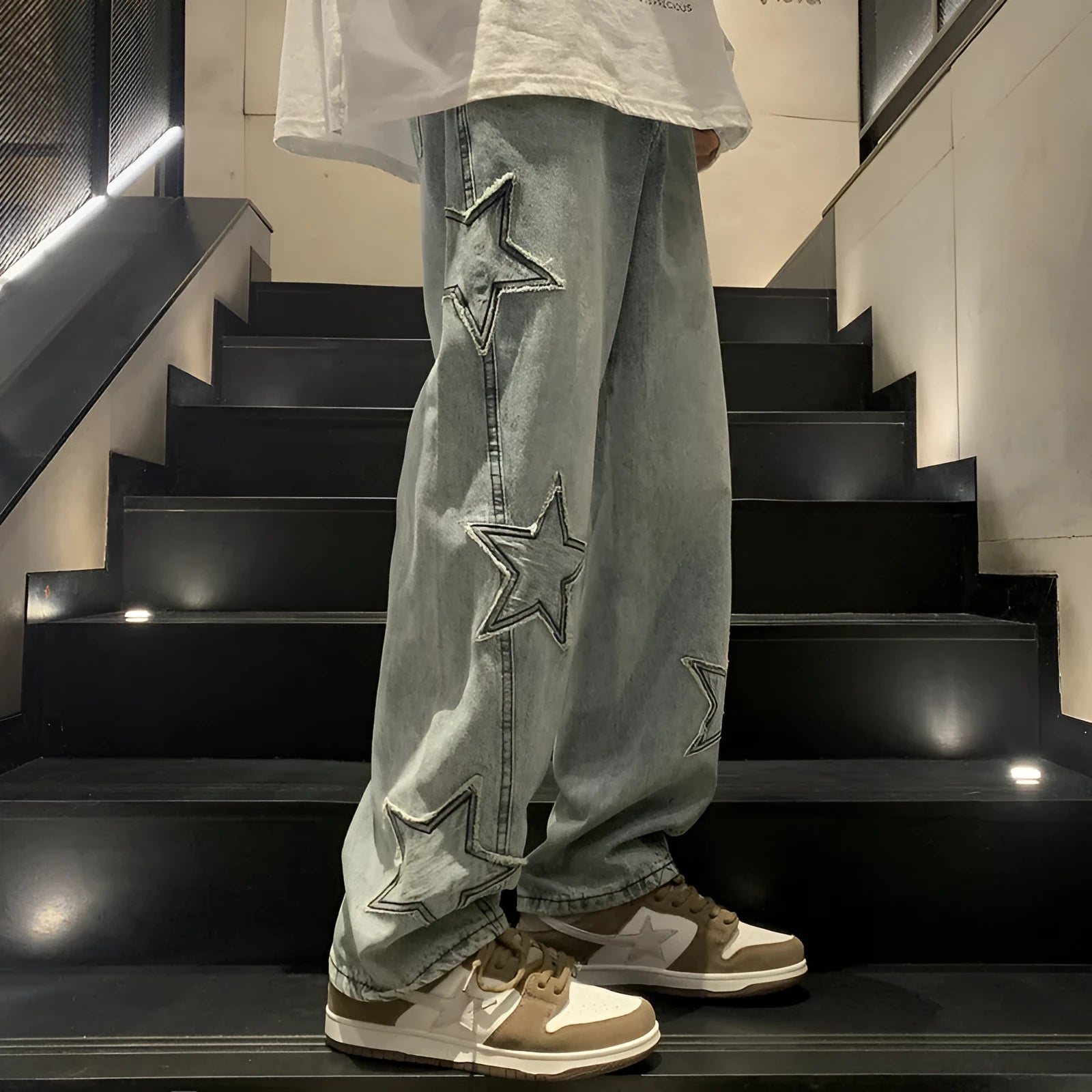 Loose fit cotton denim pants in stone washed light blue with straight leg, front view