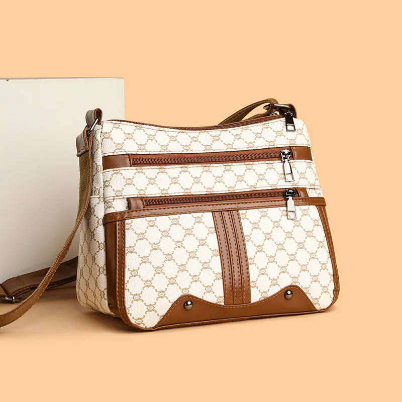 Women's brown and white stitching pattern large-capacity crossbody bag made from PU leather.