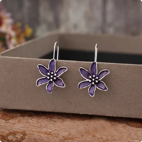 A pair of purple flower-shaped alloy earrings with a retro elegant design.