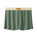 Men's solid colour loose ice silk underwear in beige, black, and grey shades laid flat