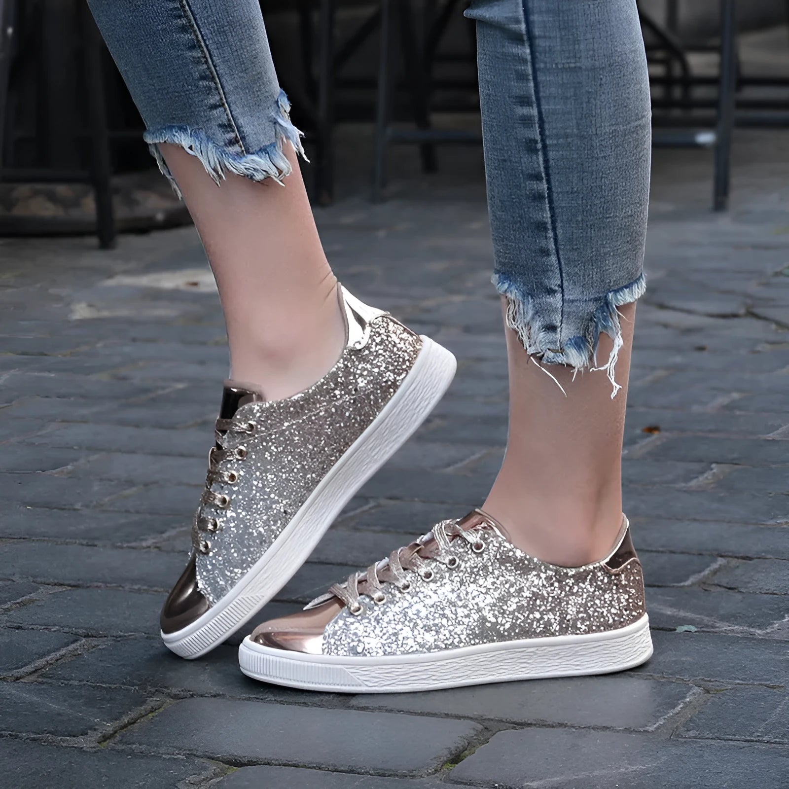 Women's black low-top casual shoes with sparkling sequinned upper and white laces.