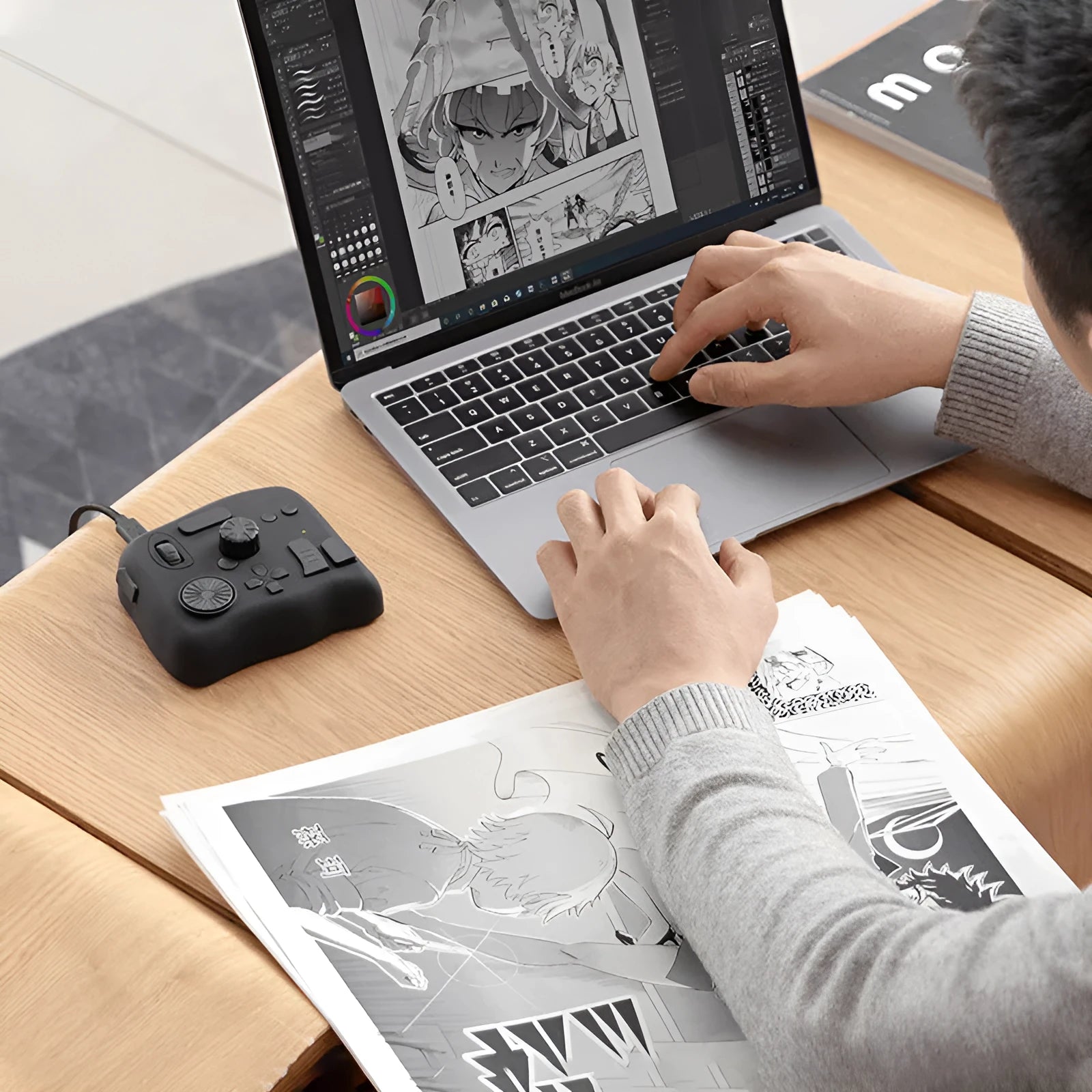 TourBox NEO video editing controller in black, showing its compact size and array of dials and buttons.