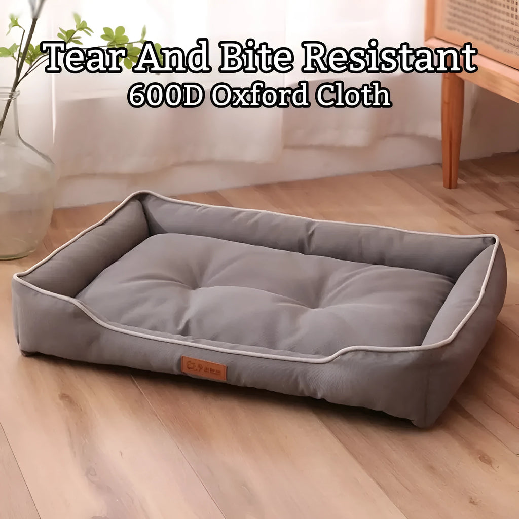 Grey waterproof dog sofa bed with a soft cushion, shown next to a sleeping golden retriever.