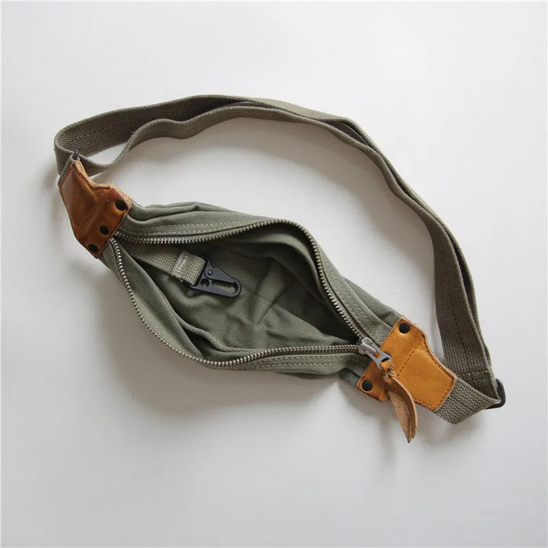 Green military style chest bag made from canvas with leather accents and anti-theft functionality