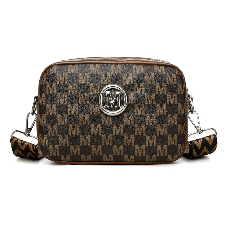 Crossbody bag with wide shoulder strap showing three-dimensional front pocket organisation