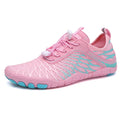 White and pink lace-up casual trainers with a non-slip rubber sole on a plain background.