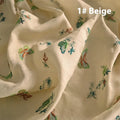 Close-up of pure ramie embroidery cloth in beige, dark green, and grass green colours, showing texture.