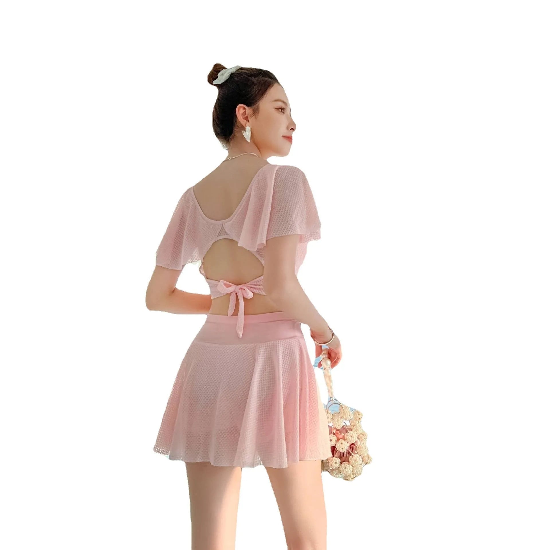 Women's solid colour two-piece swimsuit with a skirt, shown in white, black, and pink.