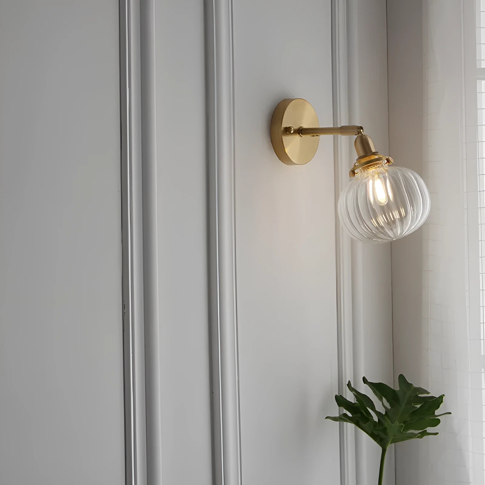 Creative pumpkin-shaped wall lamp with hand-blown water ripple glass shade mounted on a brushed nickel bracket.