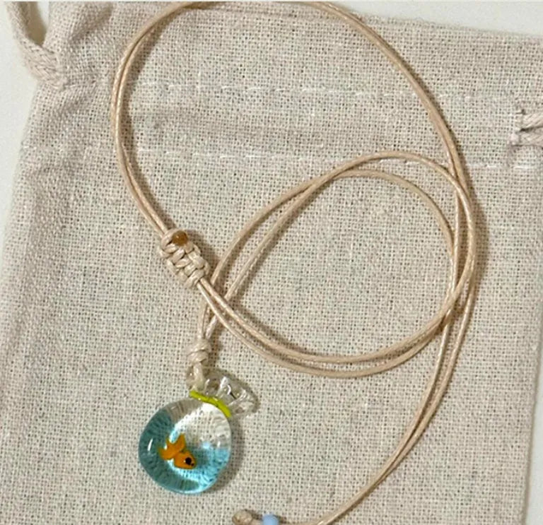 Women's coloured glaze pendant necklace on a beige cotton-linen cord, showing Skirt and Joker design details.