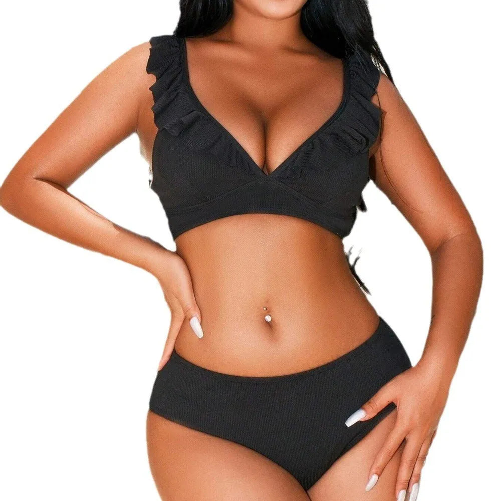 Black and white striped bikini swimsuit with a split chest design.