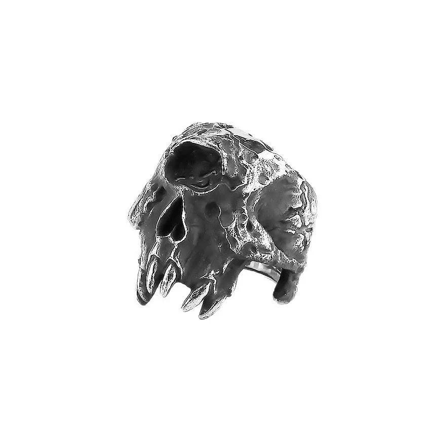 Close-up of a silver-toned alloy ring with a detailed one-eyed skull design on a finger.