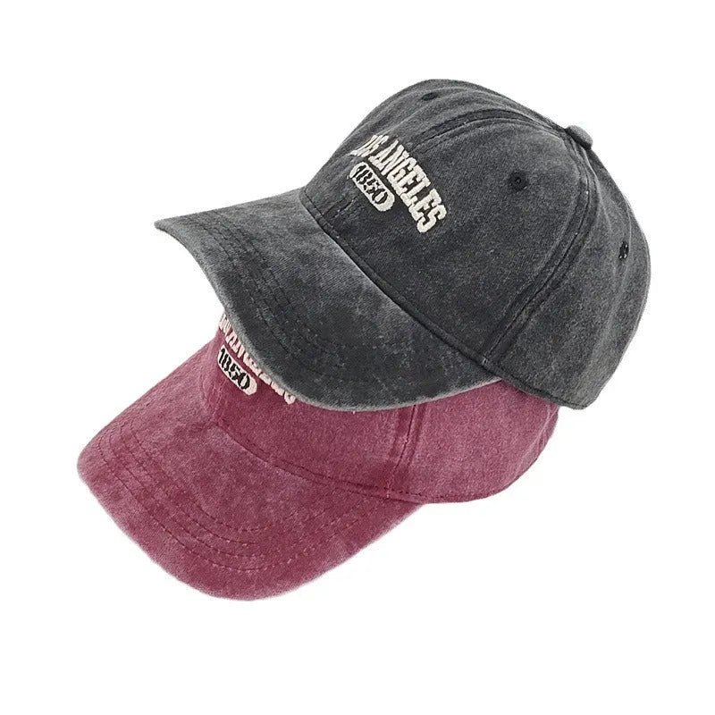 Retro personalised washed distressed peaked cap with adjustable strap and embroidered letters on the front.