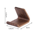 Walnut wood mobile phone bracket on a desk holding a smartphone upright for handsfree viewing