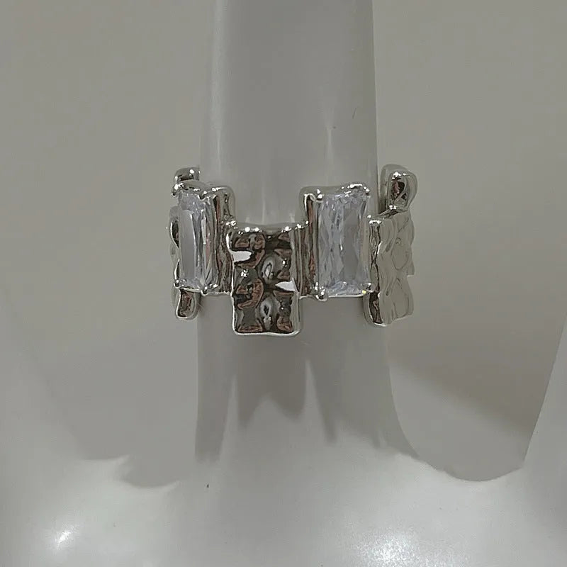 Silver geometric ring with cross zircon design and open gemstone setting