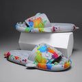 Pair of grey EVA foam open-toe slippers with a raised shark fin design on the front.
