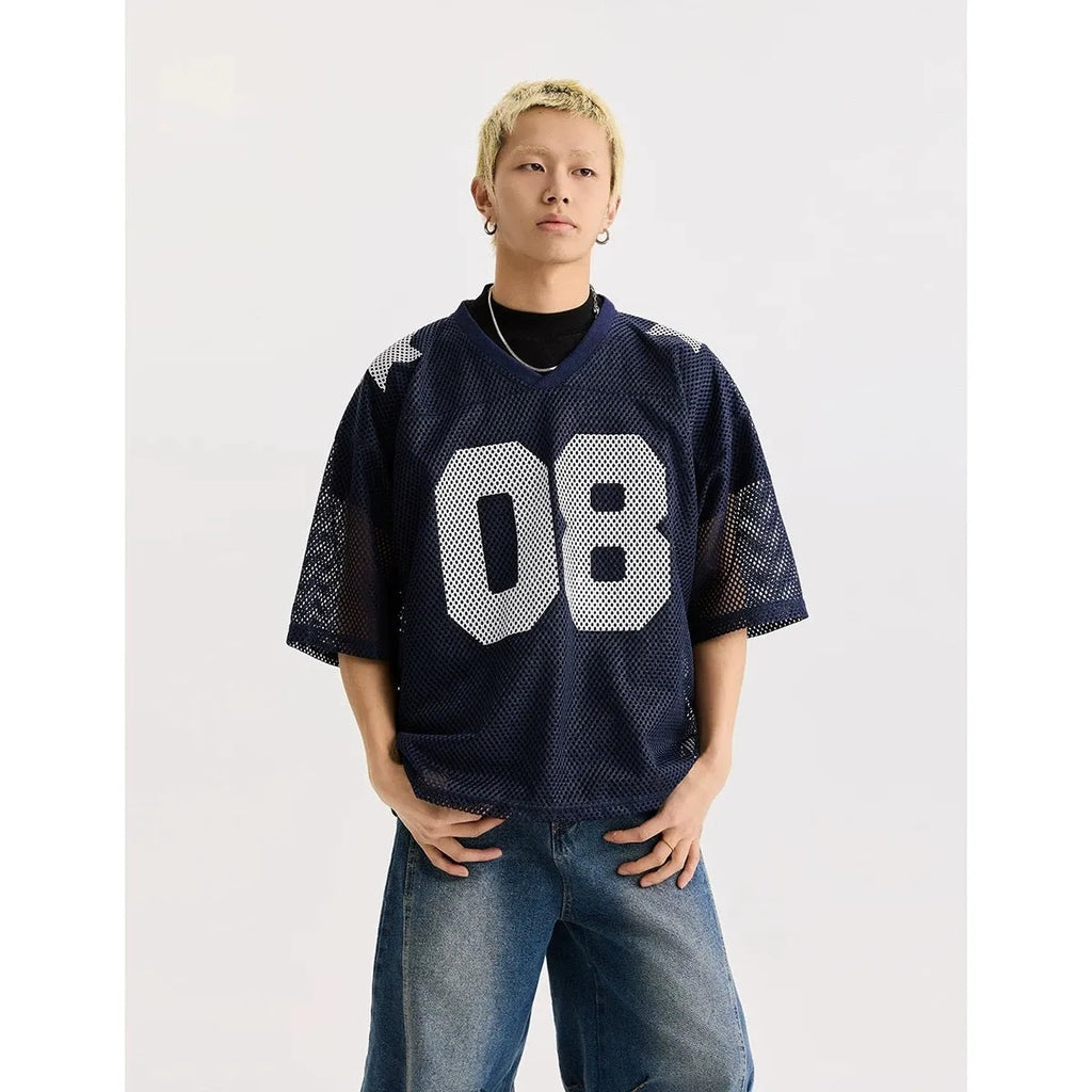 Loose fit black pullover shirt with white letters pattern print, short sleeves, on a hanger.