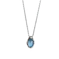 Close-up of a women's navy blue water drop pendant necklace with a platinum-colour electroplated finish on an adjustable cross chain.