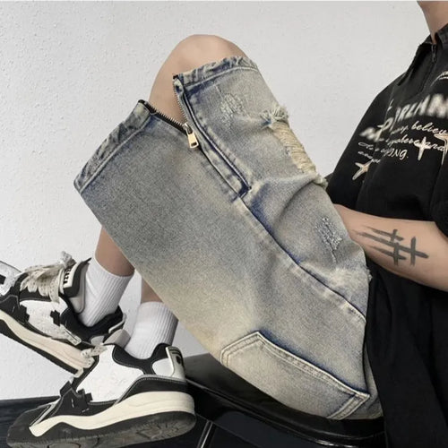 Blue retro tattered denim shorts with a wide leg loose fit on a person
