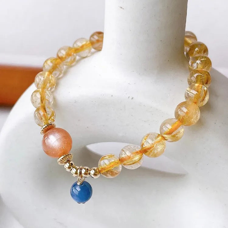Handmade natural gold rutilated quartz and sunstone crystal bracelet with round diamond-shaped elements