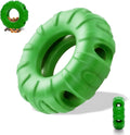 Blue rubber tyre-shaped dog chew toy with oval openings, shown next to dog treats.