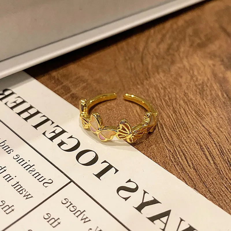 Copper butterfly women's ring with dripping oil texture and an open loop design.
