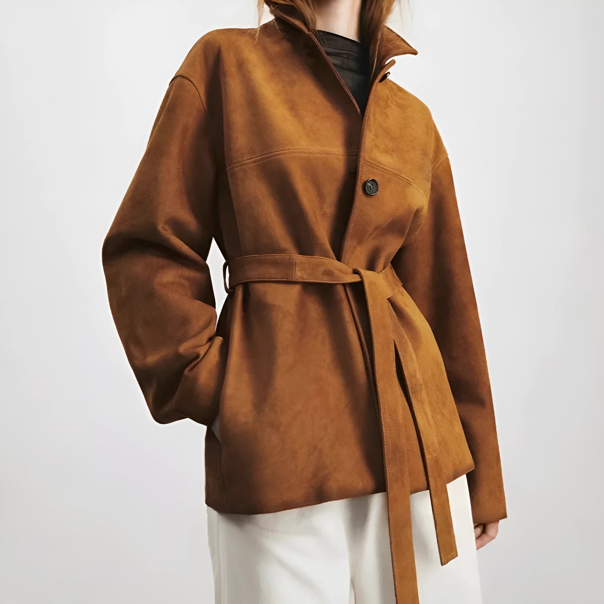 Yellow brown mid-length coat with Peter Pan collar and leather stitching on front.