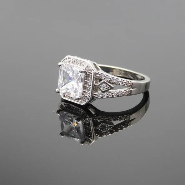 Platinum-colour hollow geometric ring with an inlaid cubic zirconia stone, shown from the side.