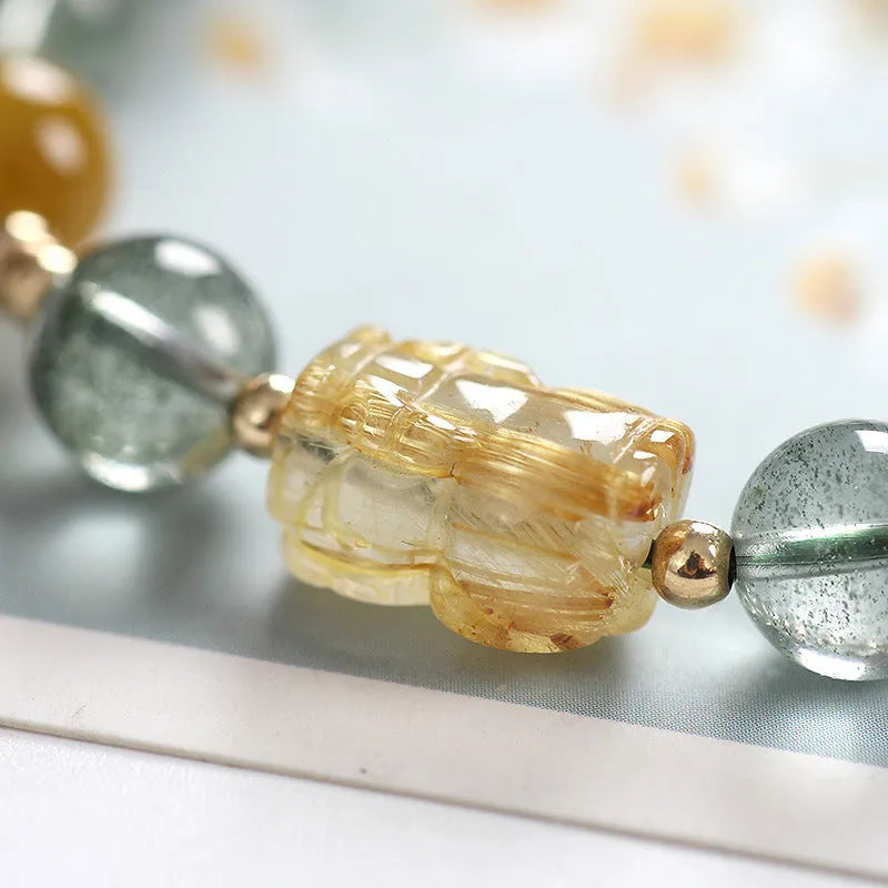 Green phantom quartz crystal bracelet with geometric design and gold rutile accents