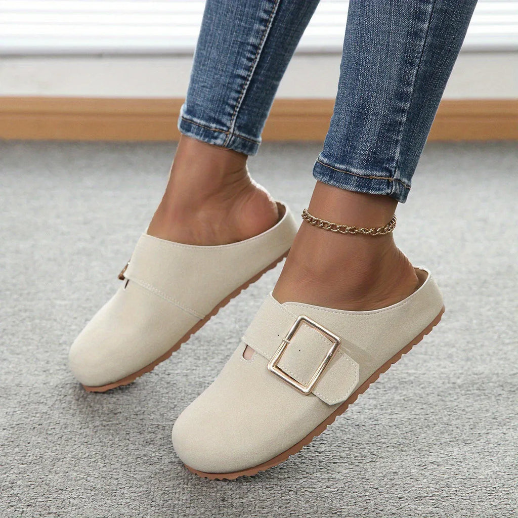 Women's brown closed toe canvas slippers with low top design showing pull-on style and textured canvas upper