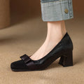 Retro square toe chunky heel pumps for women in black, with bow detail and low-cut design on a light background
