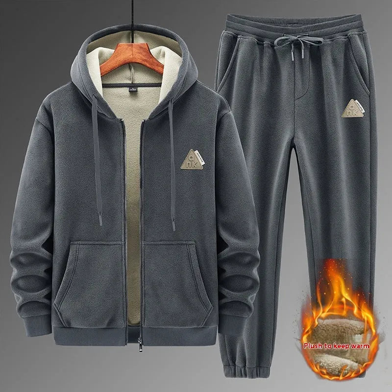 Grey hooded sweatshirt and matching trousers sports suit set laid flat