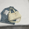 Large solid colour polyester canvas shoulder tote bag for women with outer pocket.