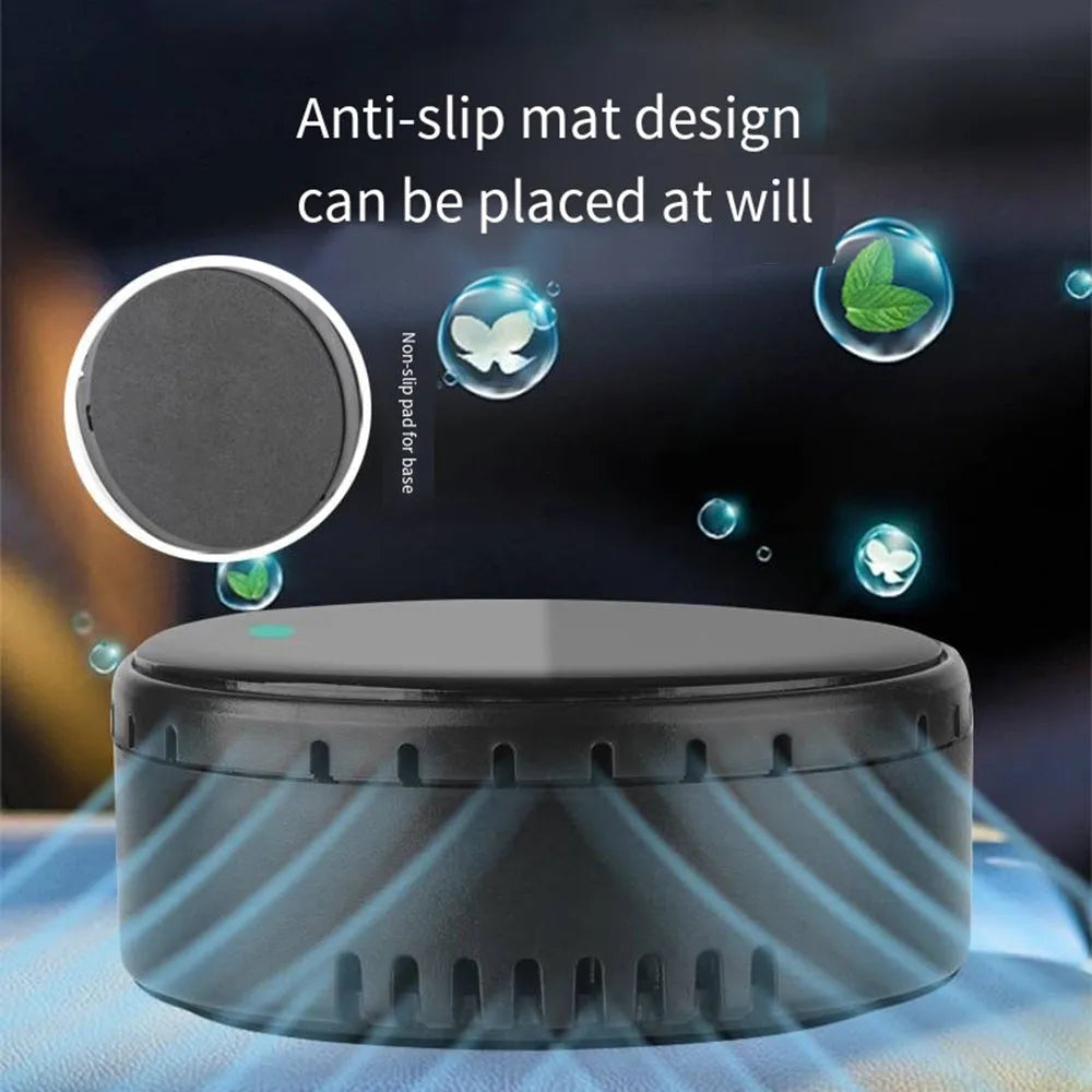 Compact black solar-powered car air humidifier installed in a vehicle air vent.