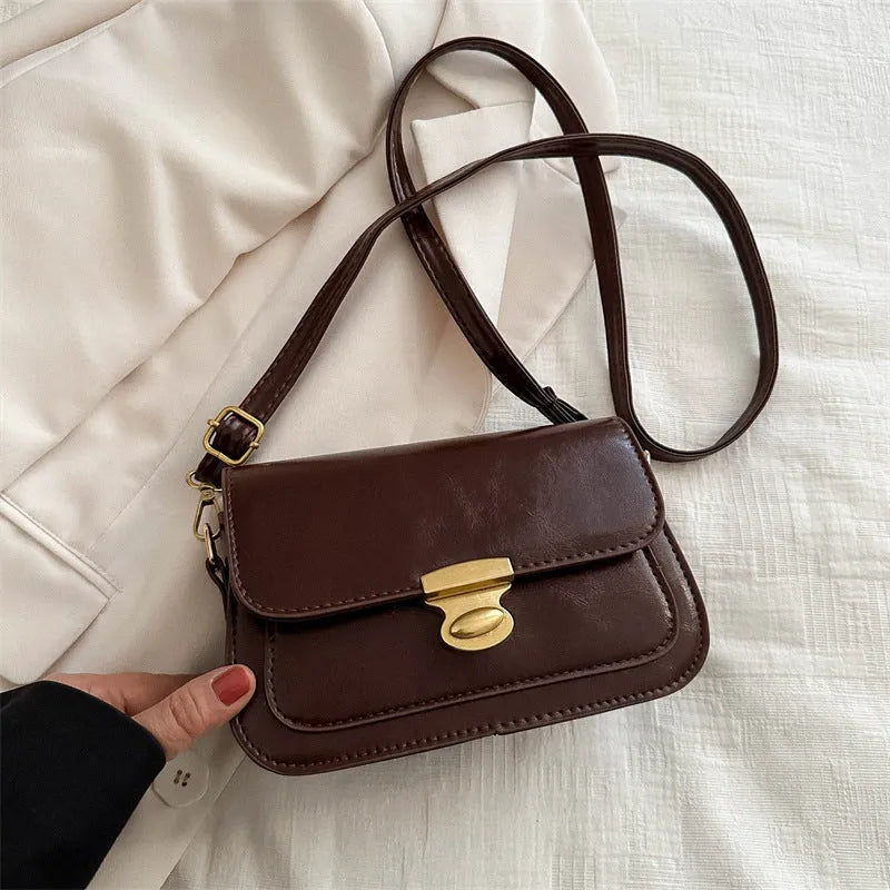 Retro small square handbag in soft brown PU leather with a horizontal shape.