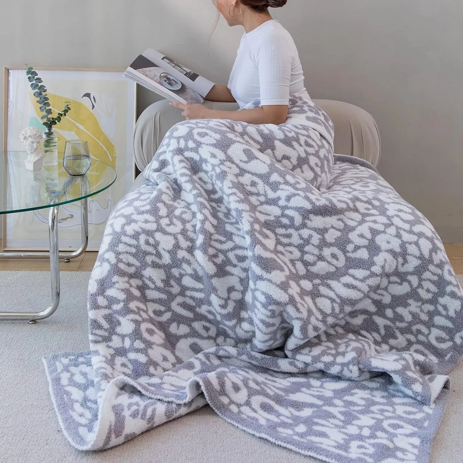 Half velvet leopard print knitted blanket in gray on a sofa, size 130x150cm
