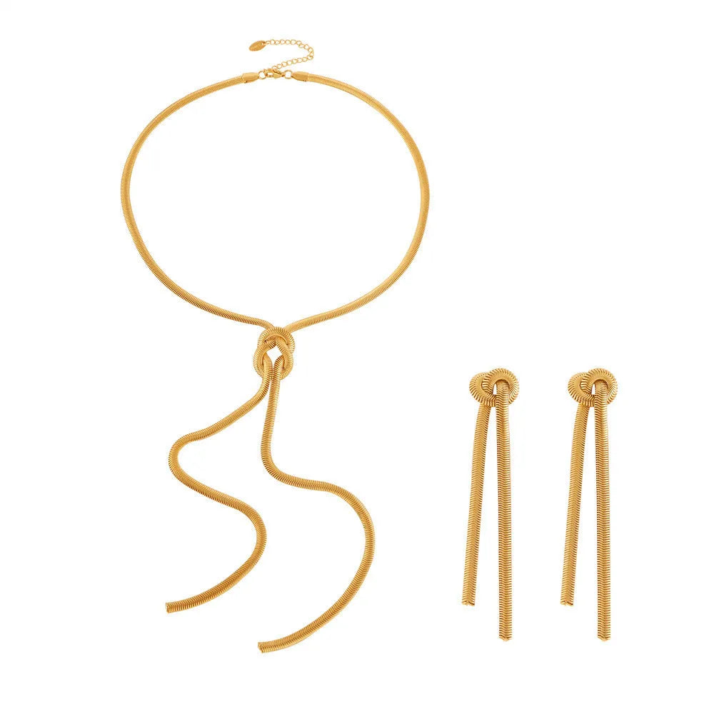 Women's gold knotted tassel necklace on snake chain with matching titanium steel earrings