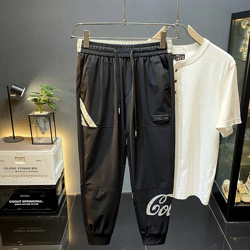 Men's black ultra-thin ice silk ankle banded casual trousers showing cropped design with elastic cuffs