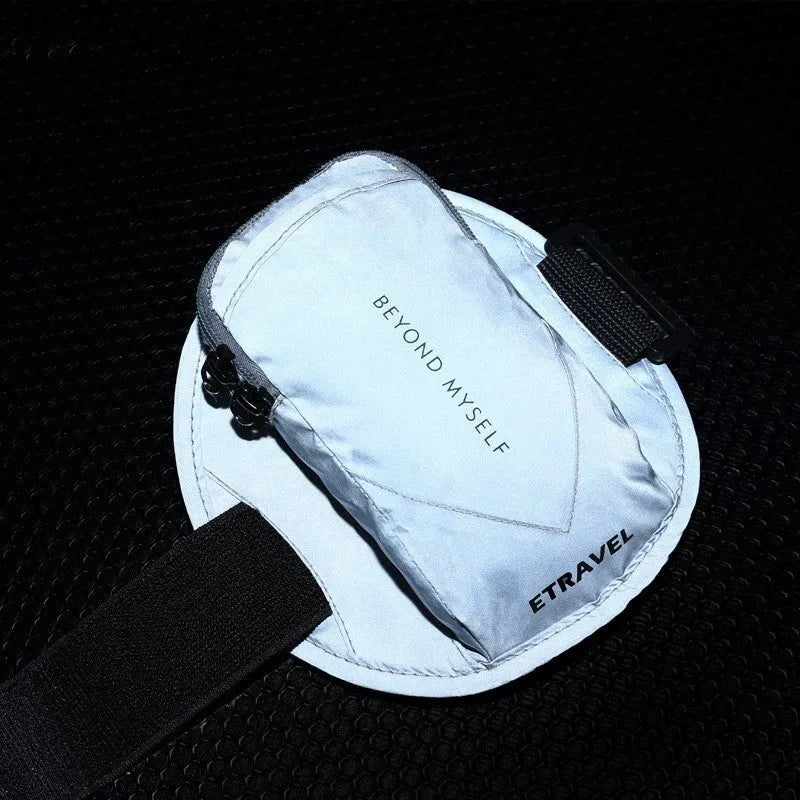 Black reflective running arm bag with adjustable strap, shown holding a smartphone, for outdoor sports safety.