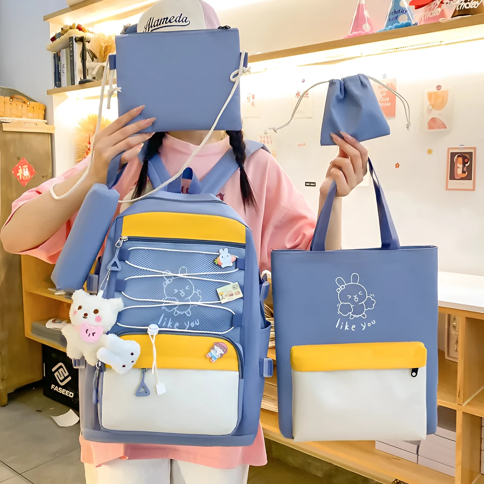 Set of four solid-colour nylon backpacks for students in pink, black, purple, and blue.